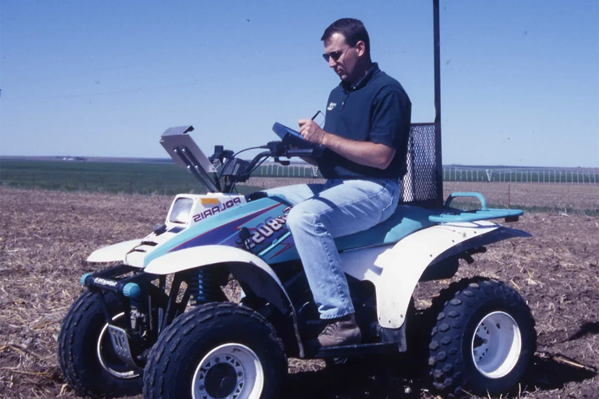 agronomist sitting on atv writing notes 2 sitting on atv taking field notes