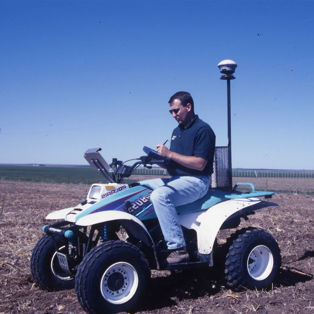 agronomist sitting on atv writing notes sitting on atv taking field notes