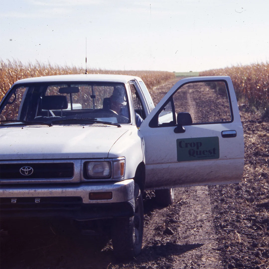 crop quest truck with door open between corn rows photo of crop quest agronomist sitting in truck between corn rows