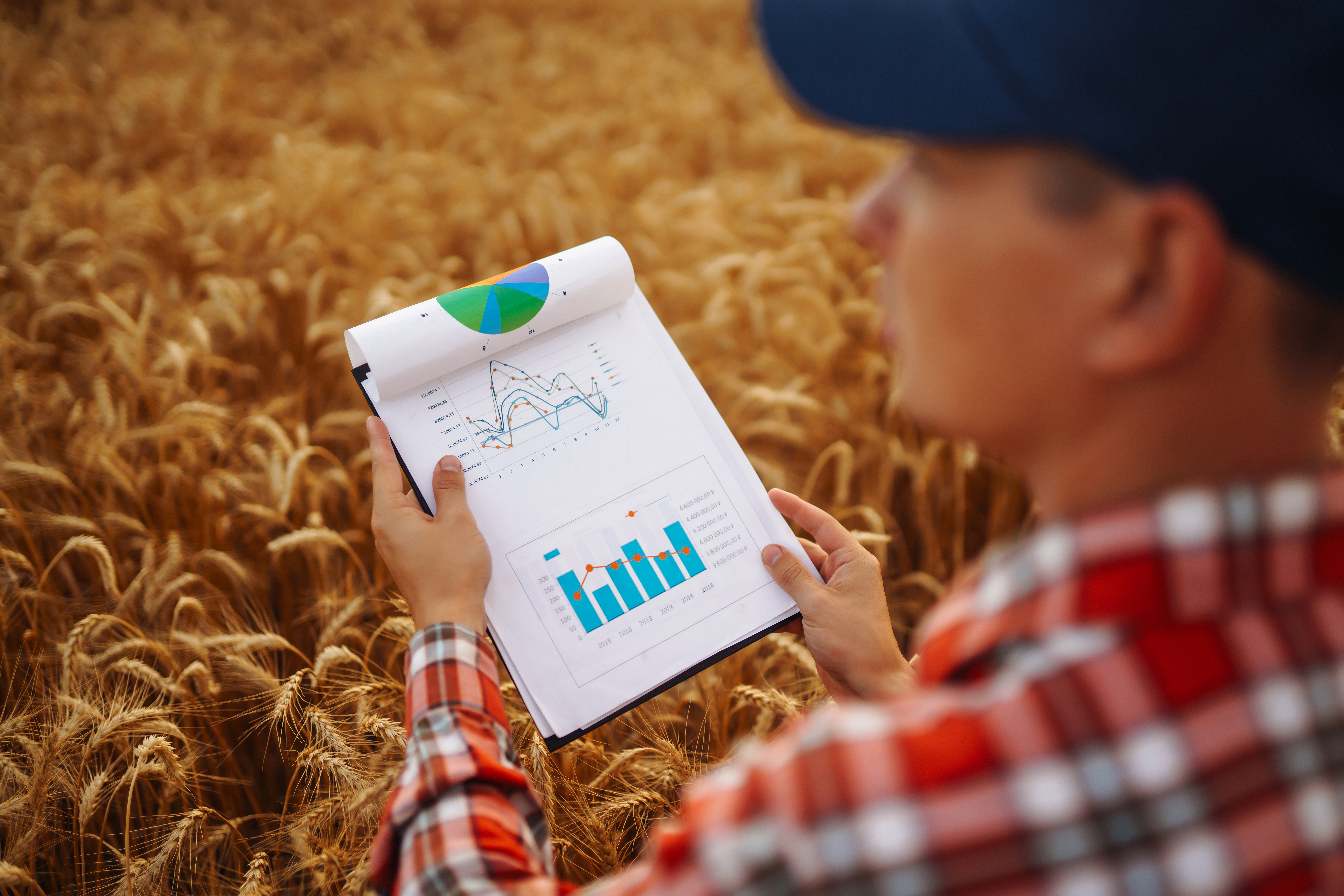 Tablet in the hands of a farmer. Smart farm. Farmer checking his crops on an agricultural field.